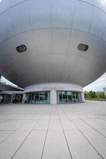 Dome-shaped modern building with prominent entrance area and architectural details, BMW Welt,