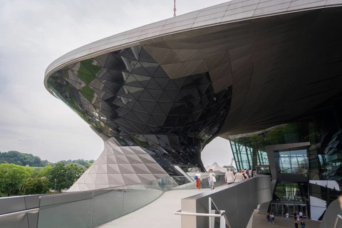 Futuristic building with reflective glass façade, leading visitors up a ramp, BMW Welt, Munich,