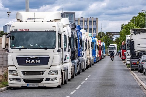 Truck tractors, exclusively from Eastern European countries, park in the harbour area, the canal