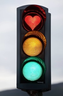 Traffic lights with green light, yellow light and red light in the shape of a heart, symbolic image
