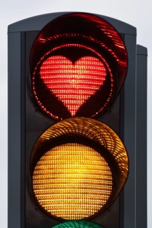 Traffic light with red light in the shape of a heart, Akureyri, North Iceland, Iceland