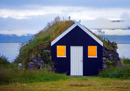 Traditional wooden hut with sod roof in the evening in Reykjadiskur at Skagafjördur, Iceland