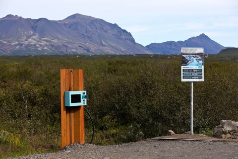 Car park at Brúarfoss waterfall with EC machines for paying in the countryside, South Iceland,