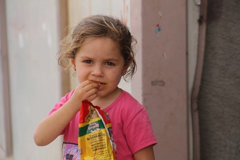 A Syrian refugee child photographed in a camp, reflecting the harsh living conditions of displaced