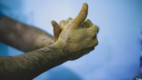 A doctor washing his hands before entering the operating room to perform surgery. Aleppo, Syria