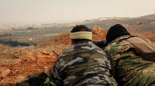Syrian opposition fighters planning military strategies in preparation for clashes with ISIS.