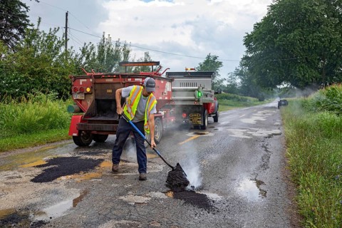 Glendora, Michigan - A worker for the Berrien County Road Department patches potholes on Wagner