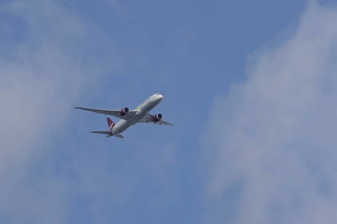 Boeing 787 Dreamliner jet passenger aircraft of Virgin Atlantic airlines in flight in a blue sky,