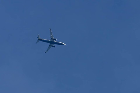 Boeing 737 jet passenger aircraft of Ryanair airlines flying in a blue sky, England, United Kingdom