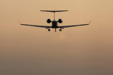 Executive business jet passenger aircraft landing at sunset, London Stansted airport, Essex,