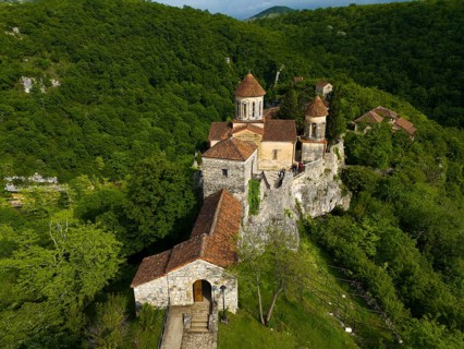 Monastery complex on a hill surrounded by a dense forest, aerial view, Motsameta Monastery, near