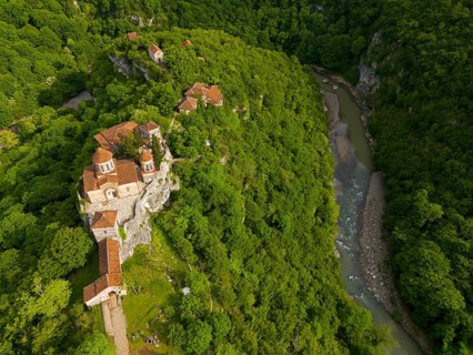 Aerial view of a monastery on a river, embedded in lush nature, aerial view, Motsameta Monastery,