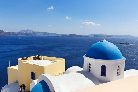 Blue dome of an orthodox church, ferry crossing the sea, Caldera, Oia, Thira, Santorini, Cyclades,