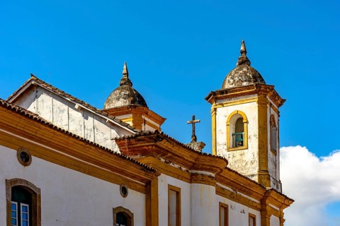 Towers and roof of a historic baroque church in the old city of Ouro Preto