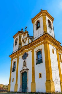 Facade of a baroque church with its towers and crucifix in Ouro Preto, Minas Gerais, Ouro Preto,
