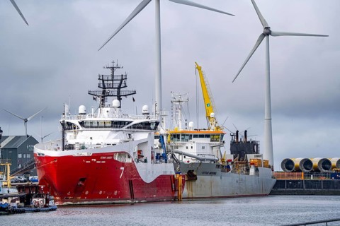Working vessels in the seaport of Eemshaven, dredger Vitus Bering, aft, cable layer and offshore