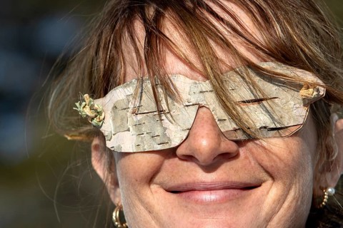 Woman wearing glasses made from birch bark, Gaspesie national park, Province of Quebec, Canada,