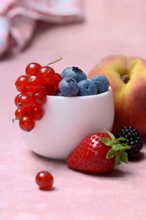Various fruits in peel, redcurrant, peach, strawberry, blueberry, blackberry