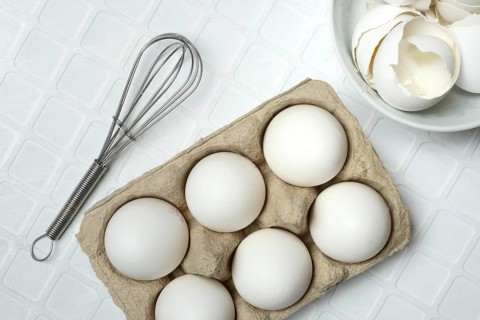 White eggs in packaging with beaters