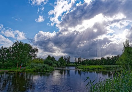 Sun and clouds over the River Trave in Brenner Moor. The Brenner Moor is a salt moor, FFH area, in