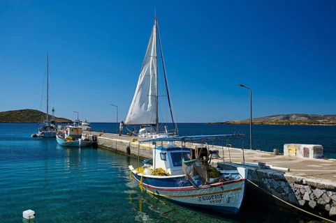 Boats are moored along a pier on the calm blue water, Analipsi, Maltezana, Astypalea, Astipalea,