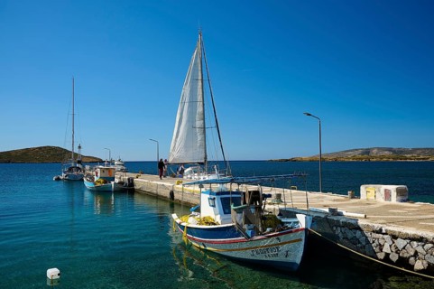 Two boats are moored at a pier, a sailing boat sails past, Analipsi, Maltezana, Astypalea,