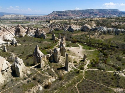 Wide valleys and impressive rock formations stretch out in Cappadocia, aerial view, Love Valley,