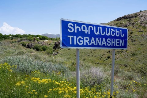 Road sign of Tigranashen in front of a hilly landscape with wild flowers, K?rk, Karki or