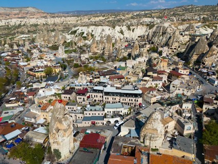 Cityscape in Cappadocia with numerous buildings and characteristic rock formations, aerial view,
