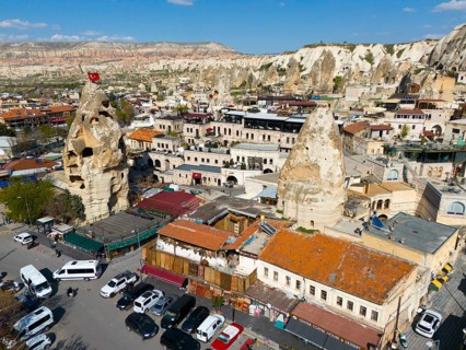 Historical buildings in combination with impressive rock formations with an urban backdrop, aerial