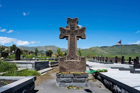 Detailed stone cross monument in a peaceful landscape at a cemetery, Gyumri, Alexandropol,