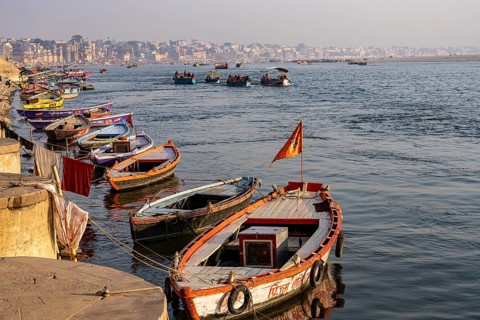 River Ganges with boats and Varanasi in the background, Shivala, Varanasi, Uttar Pradesh, India