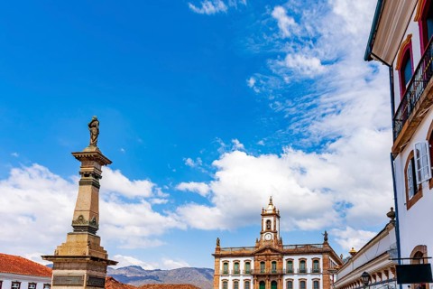 Historic facades and a statue of Tiradentes in the central square of the historic city of Ouro