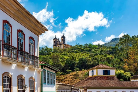 Facades of colonial houses and a baroque church in the historic city of Ouro Preto, Ouro Preto,