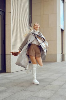 A model captures attention on a bustling city sidewalk, showcasing a trendy ensemble featuring a