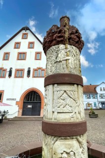 Fairy tale fountain with in the centre stone relief half relief above motif column small tower with