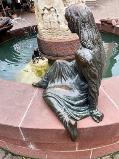 Sculptures figures of princess and frog holding golden ball representation from fairy tale the frog