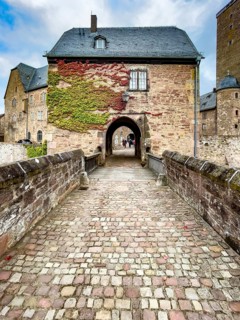 Front access with historic bridge over moat Hirschgraben to gatehouse of Steinau Castle, Steinau an
