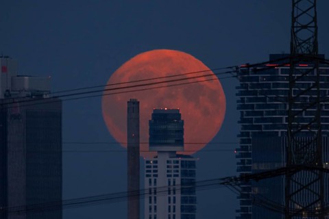 The full moon rises behind the Henniger Tower in Frankfurt am Main, Frankfurt am Main, Hesse,
