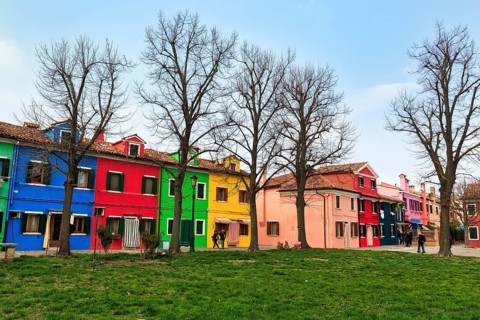 Strollers, typical street scene in winter, colourful facades of fishermen's houses in Burano,