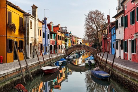 Pedestrian bridge, arched bridge over canal, typical street scene in winter, colourful facades in
