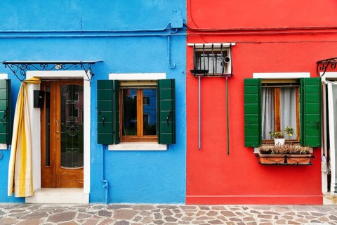 Colourful facade detail, broom hanging on the wall, Burano, island in the lagoon of Venice, Italy