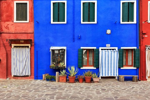 Façade detail, red and blue, various flower pots, Burano, island in the lagoon of Venice, Italy