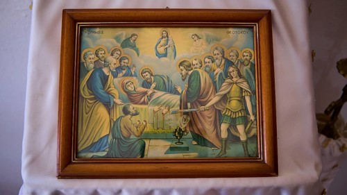Biblical icon in a wooden frame shows a religious scene with disciples and saints, hand separation,