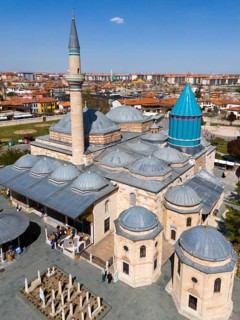 Detailed mosque with decorated dome and minaret in the background of the city view, aerial view,