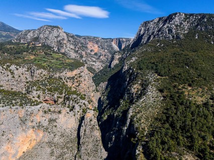 View of an extensive canyon landscape with rugged rocks and lush greenery, aerial view, Saklikent