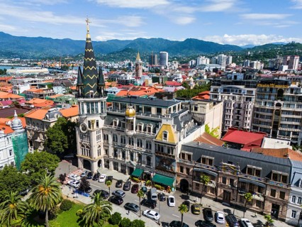 City view with impressive, historically inspired buildings in front of a mountain panorama, aerial