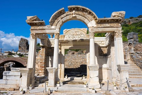 Ancient ruins with an ornate arch and columns against a blue sky, Hadrian's Temple, Efes, Ephesus,