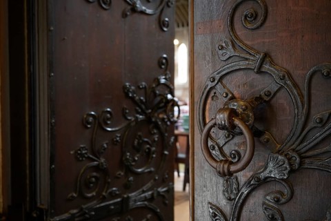 Solid wooden door with ornate iron fittings and door knocker, St Mary Abbot Church, Kensington,