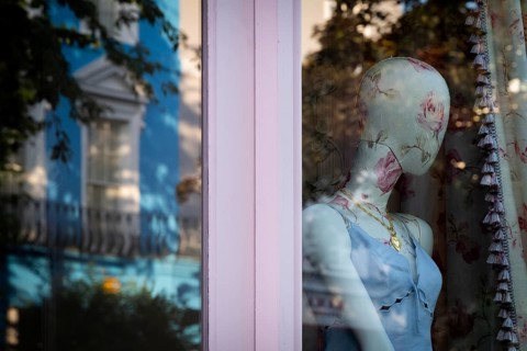 Mannequin in floral pattern, reflection in shop window, Portobello Road, Notting Hill, London,